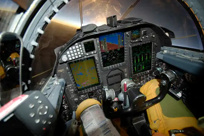A test pilot in a cockpit, with data charts overlaid, during a test flight.